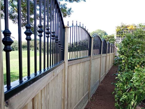 Metal railings on timber fence Cambridgeshire